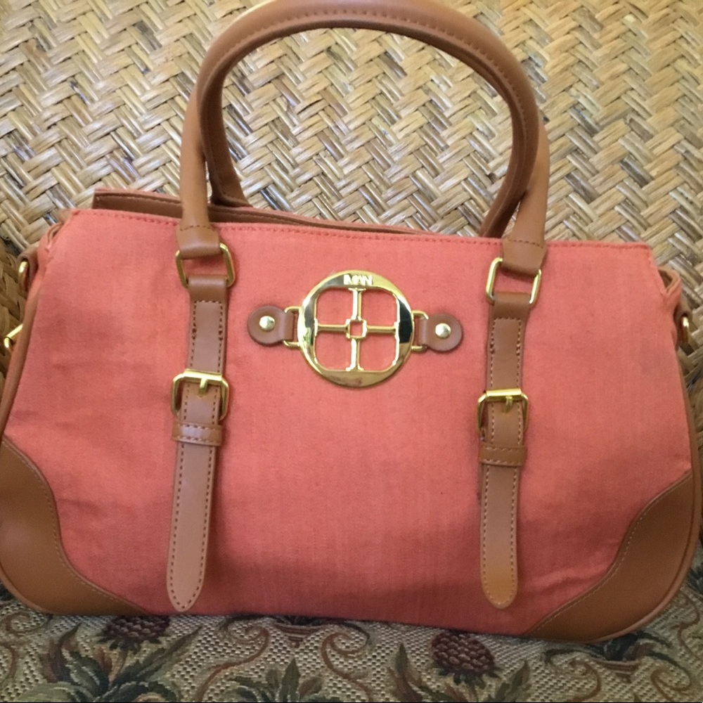 New without tags Iman orange canvas and tan trim bag with shoulder strap.